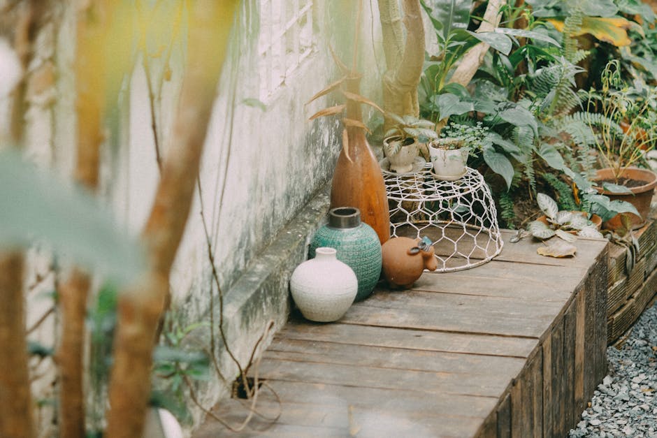 Cozy outdoor patio area adorned with various decorative vases and lush greenery for a tranquil setting.